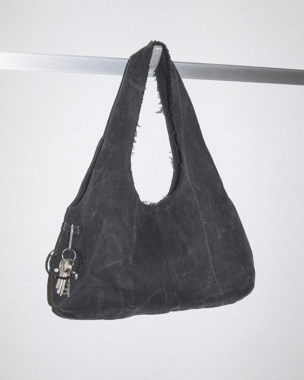 Black handbag made from black denim jeans with keys and bag charm