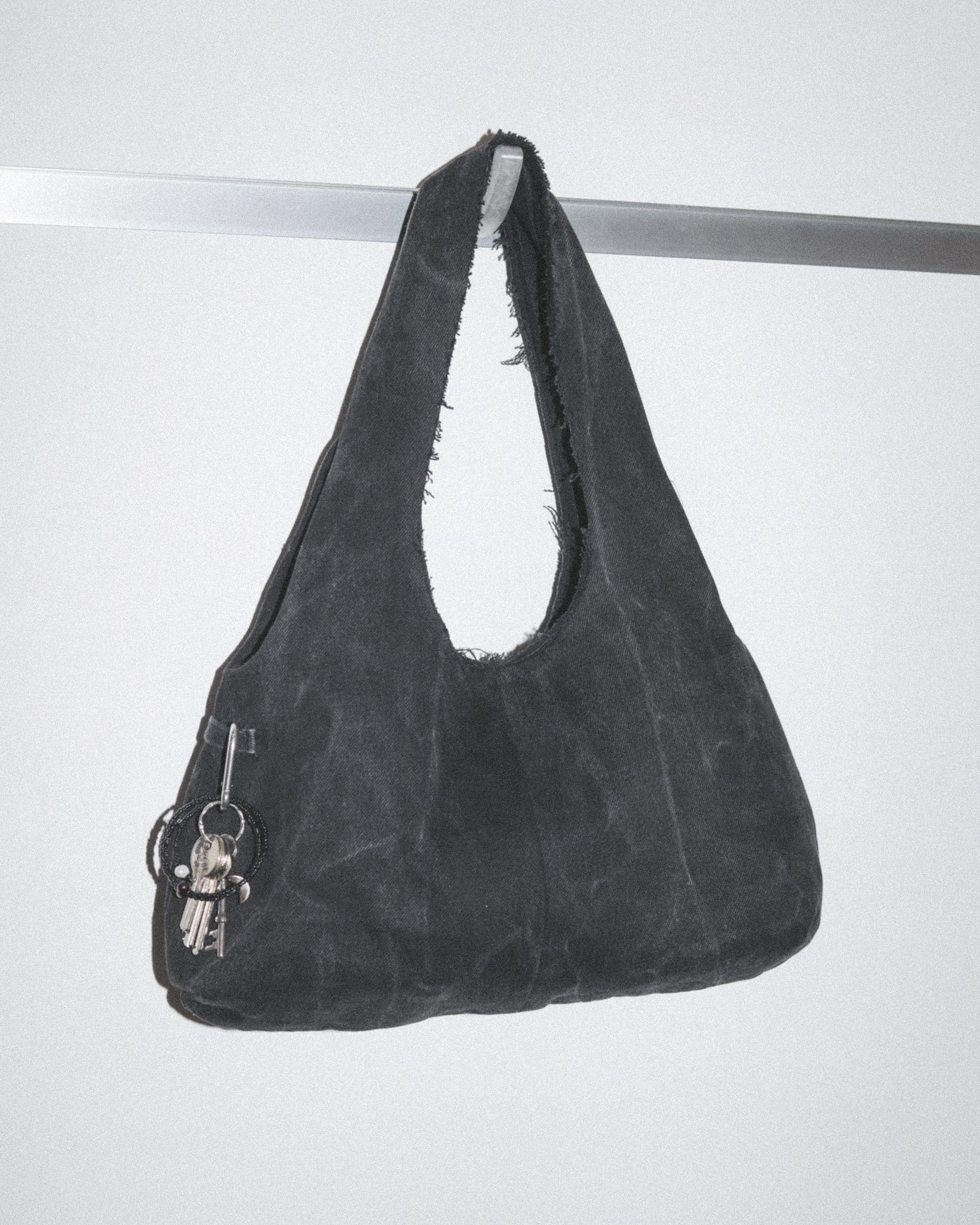 Black handbag made from black denim jeans with keys and bag charm
